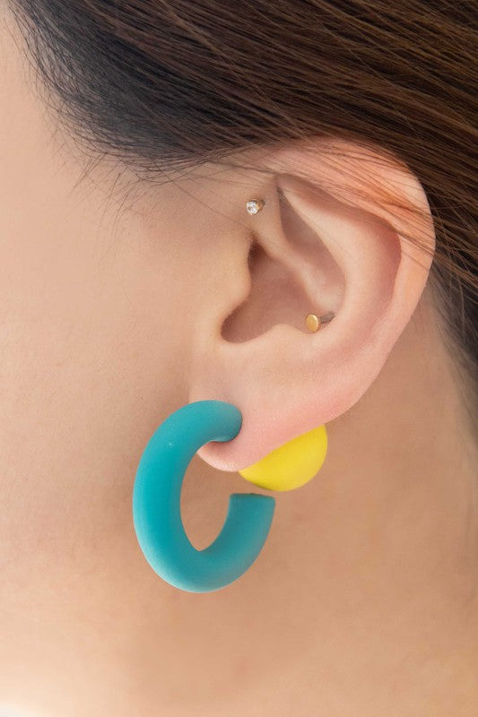 A pair of brightly colored Hula Hoop earrings with pink half-circle shapes and sterling silver posts on a white background.