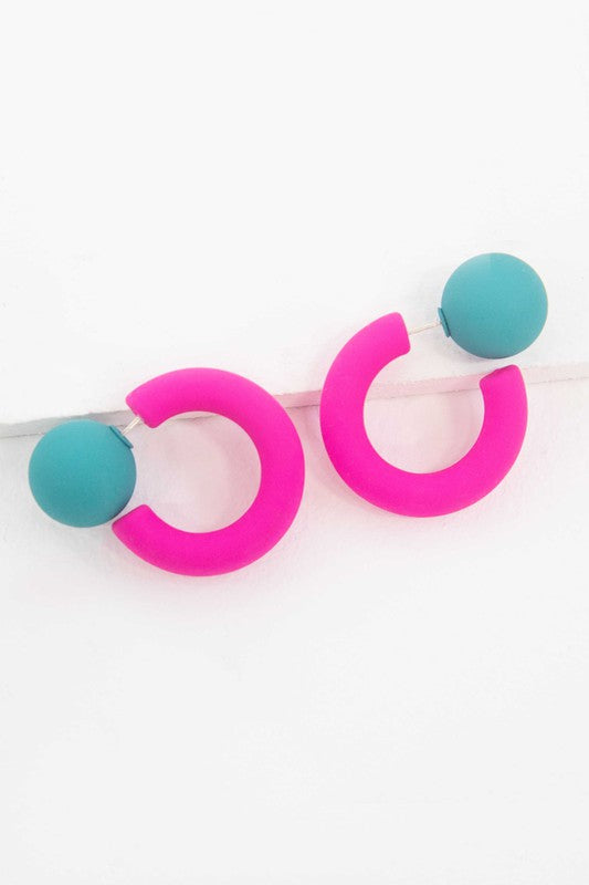 A pair of brightly colored Hula Hoop earrings with pink half-circle shapes and sterling silver posts on a white background.
