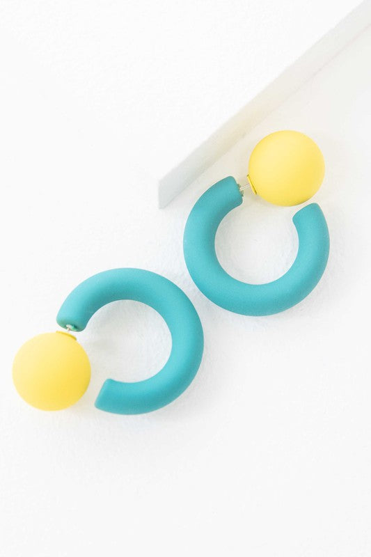 A pair of brightly colored Hula Hoop earrings with pink half-circle shapes and sterling silver posts on a white background.