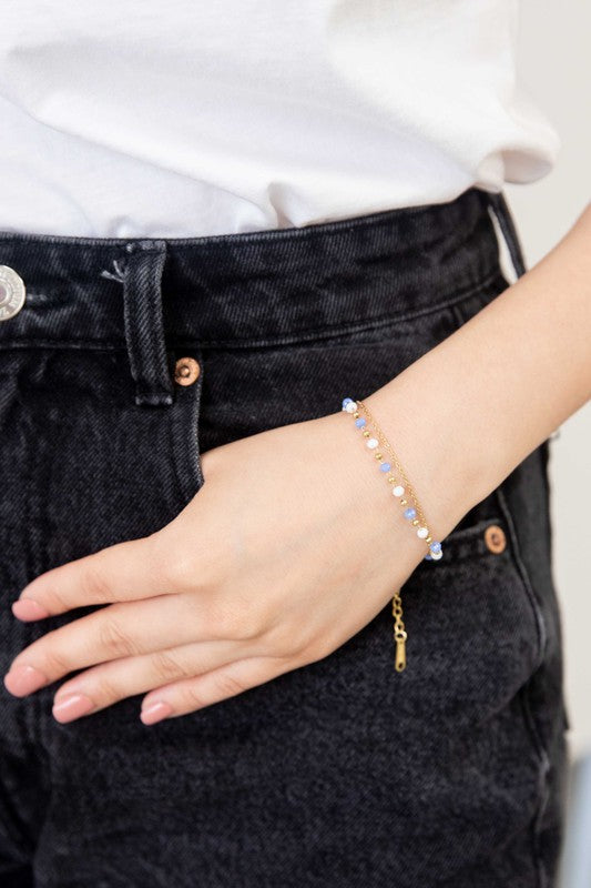 Cana Beaded Bracelet with blue bead accents on a white background and 14k gold plating.