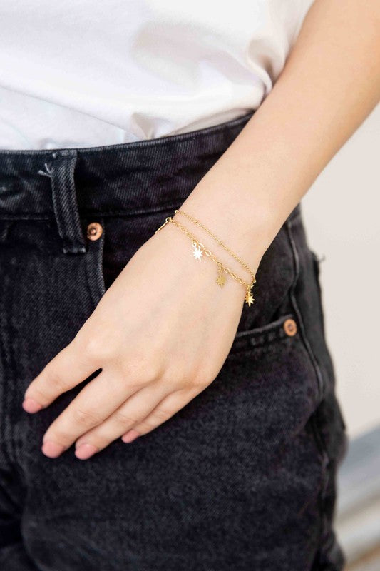 Sparks Bracelet with star charms and 14k gold plating.