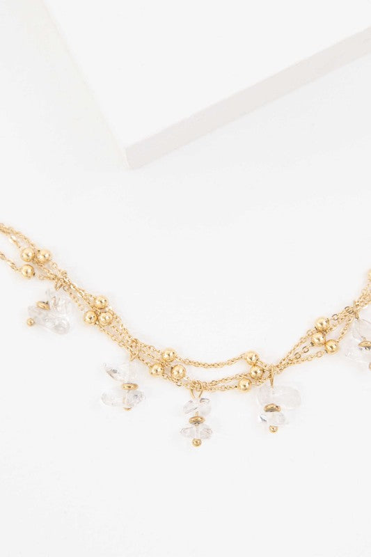 Aura Stone Bracelet with dangling clear gem accents.