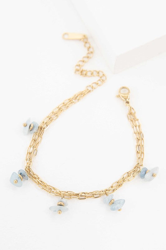 Stepping Stones Bracelet with blue stone charms against a white background.