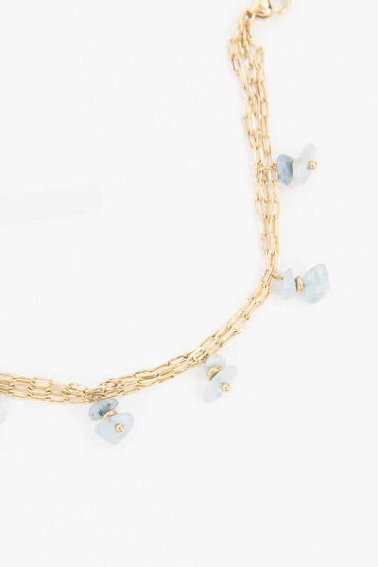 Stepping Stones Bracelet with blue stone charms against a white background.