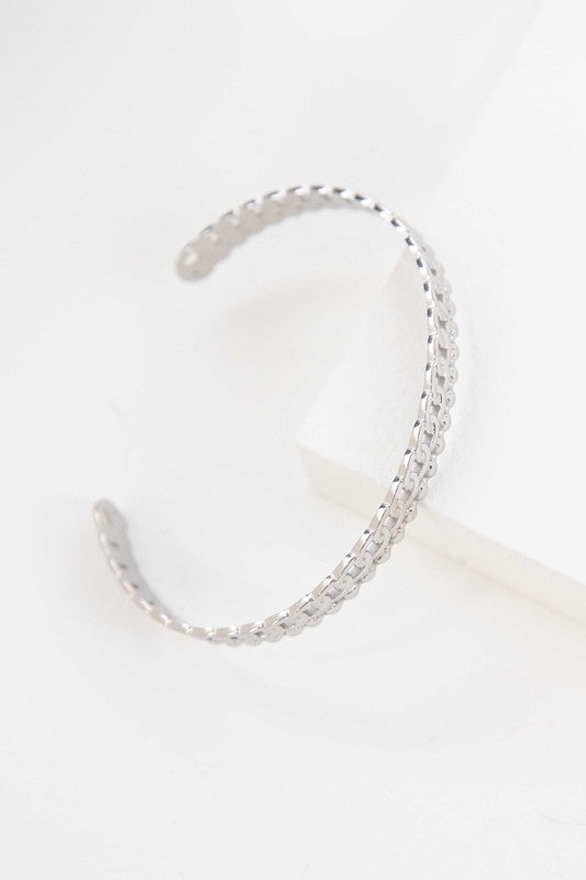 Two Sequenced Cuff Bracelets with stainless steel decorative patterns on a white background.