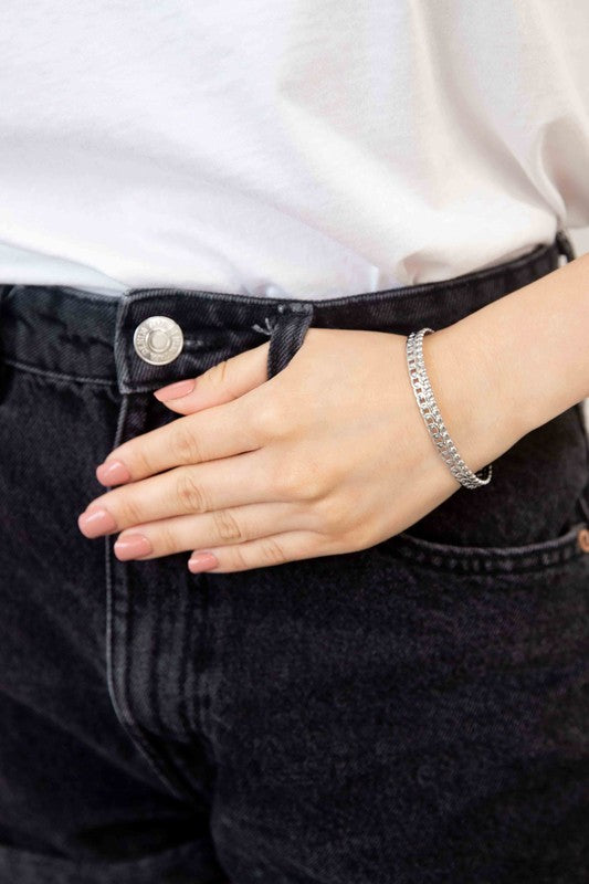 Two Sequenced Cuff Bracelets with stainless steel decorative patterns on a white background.