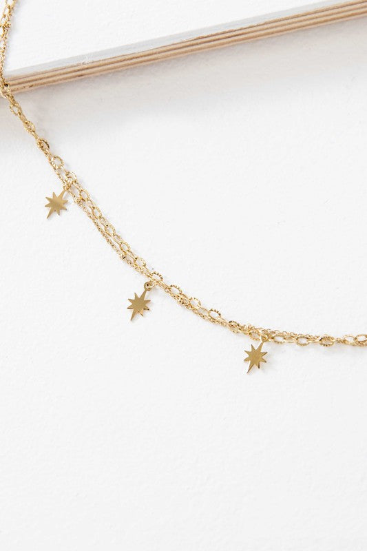 Sparks Layered Necklace with small star-shaped pendants on a white background.