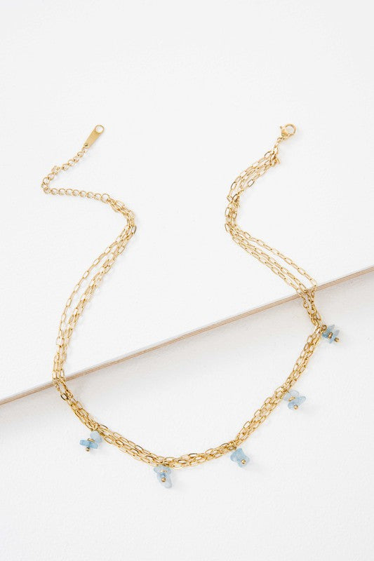Stepping Stones Necklace with blue accent beads and 14k gold plating.