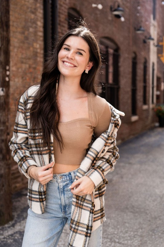 Woman wearing Ghost Studs, smiling and touching her hair.