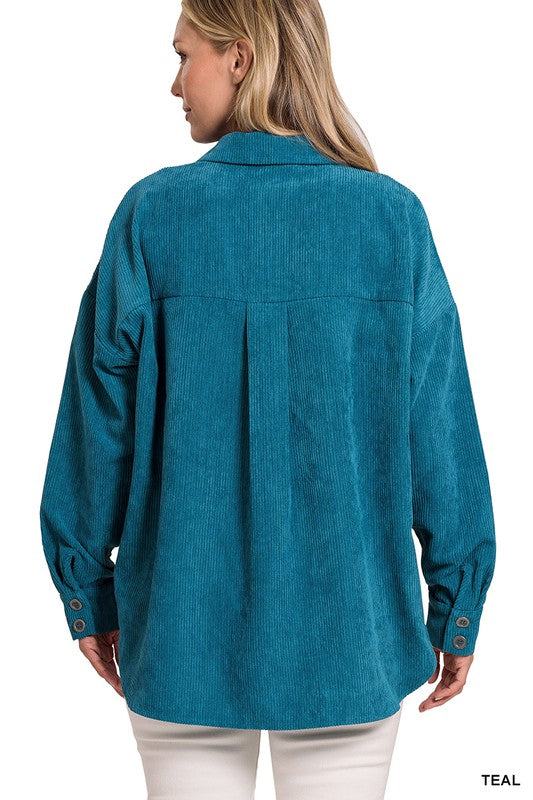 A woman smiling and wearing the Oversize Corduroy Shacket in teal over a white top, perfect for casual outings in your fall and winter wardrobe.