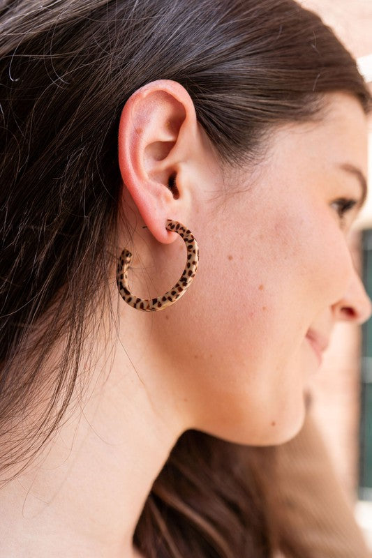 Pair of lightweight Camy Hoops - Brown Dot acrylic earrings with clear backings displayed on a white dish.