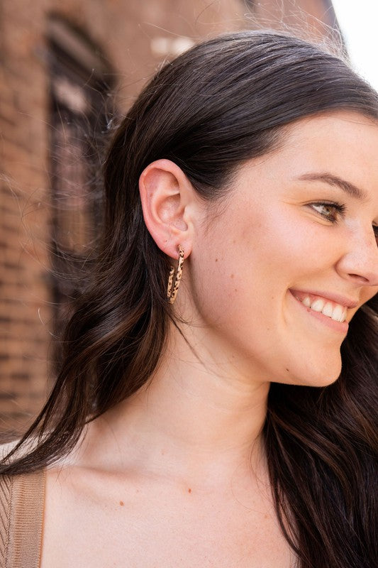 Pair of lightweight Camy Hoops - Brown Dot acrylic earrings with clear backings displayed on a white dish.