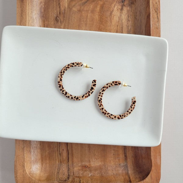 Pair of lightweight Camy Hoops - Brown Dot acrylic earrings with clear backings displayed on a white dish.