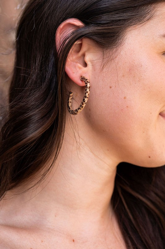 Pair of lightweight Camy Hoops - Brown Dot acrylic earrings with clear backings displayed on a white dish.