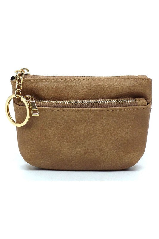 The Fashion Keychain Coin Purse is a compact, textured brown coin holder made from vegan leather. It features a zippered closure, an external pocket, and comes with an attached gold keyring.
