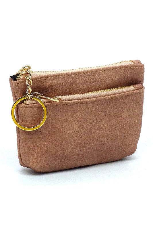 The Fashion Keychain Coin Purse is a compact, textured brown coin holder made from vegan leather. It features a zippered closure, an external pocket, and comes with an attached gold keyring.
