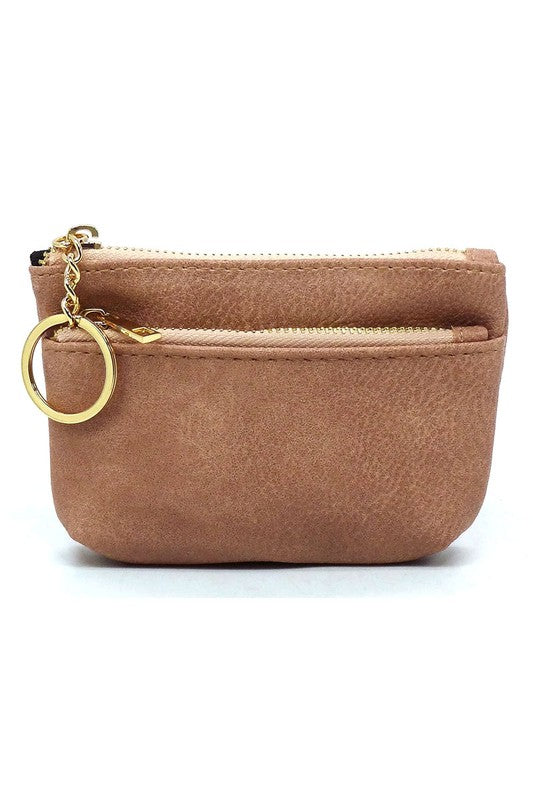 The Fashion Keychain Coin Purse is a compact, textured brown coin holder made from vegan leather. It features a zippered closure, an external pocket, and comes with an attached gold keyring.