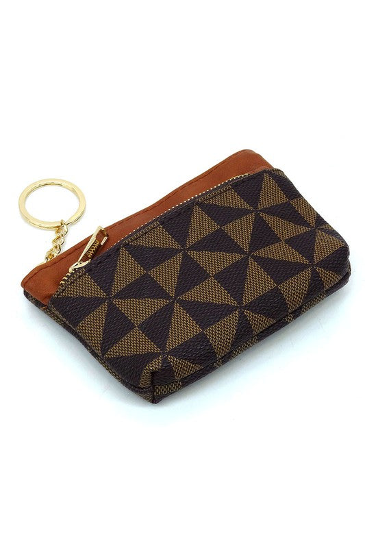 The PM Monogram Keychain Coin Purse, crafted from faux vegan leather, showcases a geometric black and white pattern with a secure black zipper closure and an attached gold keyring.