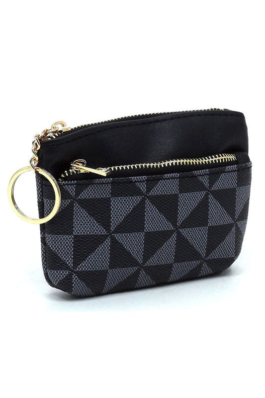 The PM Monogram Keychain Coin Purse, crafted from faux vegan leather, showcases a geometric black and white pattern with a secure black zipper closure and an attached gold keyring.