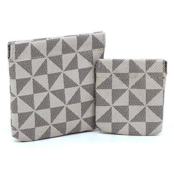 The PM Monogram Spring Zip 2-in-1 Coin Purse includes two fabric bags, one larger and one smaller, adorned with a black and white geometric triangle pattern. These bags feature a convenient spring zip closure and gold-tone hardware for an elegant finish.