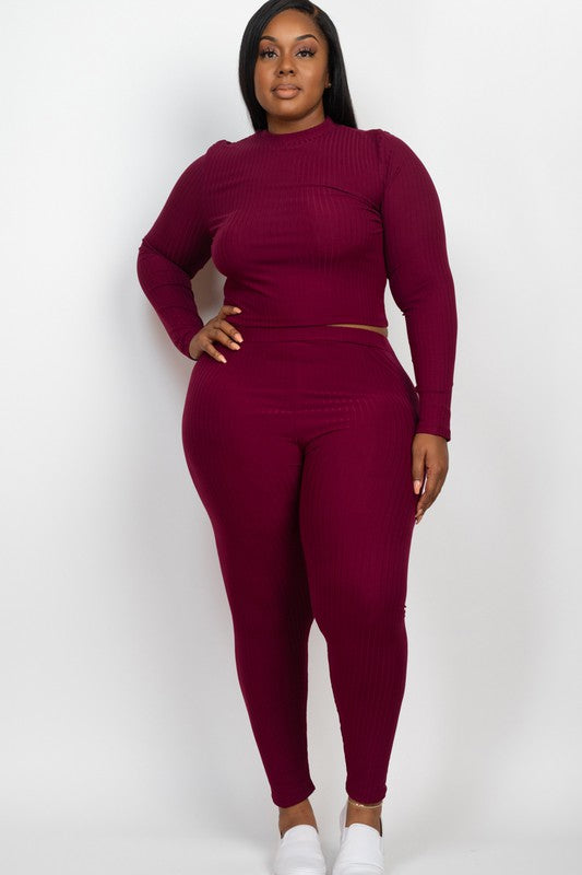 A person is wearing a Plus Ribbed Mock Neck Long Sleeve Top&Leggings Set in burgundy, paired with white shoes, standing against a plain white background.