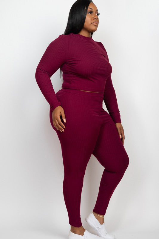 A person is wearing a Plus Ribbed Mock Neck Long Sleeve Top&Leggings Set in burgundy, paired with white shoes, standing against a plain white background.