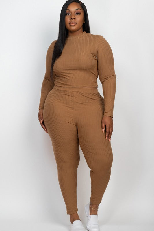 A person is wearing a Plus Ribbed Mock Neck Long Sleeve Top&Leggings Set in burgundy, paired with white shoes, standing against a plain white background.