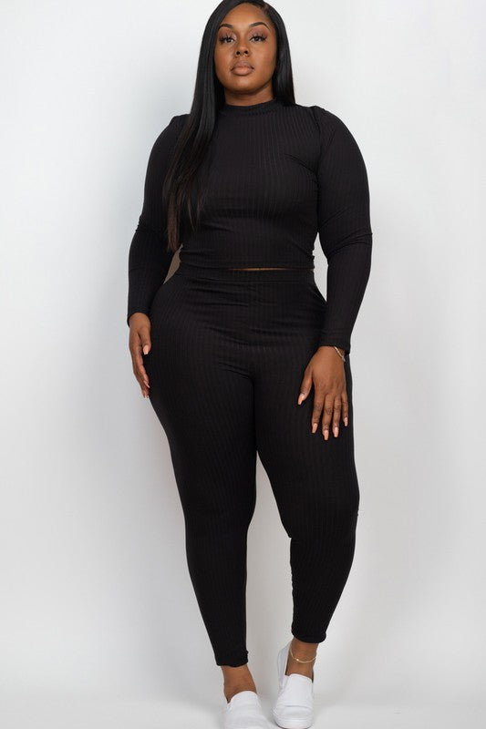 A person is wearing a Plus Ribbed Mock Neck Long Sleeve Top&Leggings Set in burgundy, paired with white shoes, standing against a plain white background.