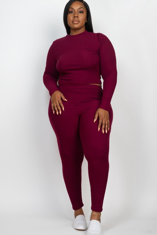 A person is wearing a Plus Ribbed Mock Neck Long Sleeve Top&Leggings Set in burgundy, paired with white shoes, standing against a plain white background.