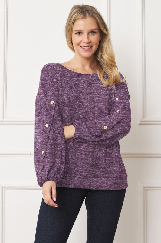 A woman is standing and smiling, wearing the Drop Shoulder Button Sleeve Detail Top in brown and dark pants.