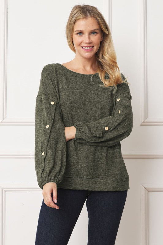 A woman is standing and smiling, wearing the Drop Shoulder Button Sleeve Detail Top in brown and dark pants.