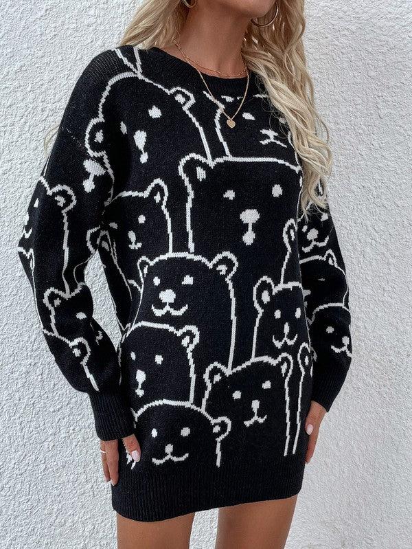 A person wearing a Womens Long Sleeve Round Neck Pullover Sweater adorned with multiple bear faces stands against a white textured wall.