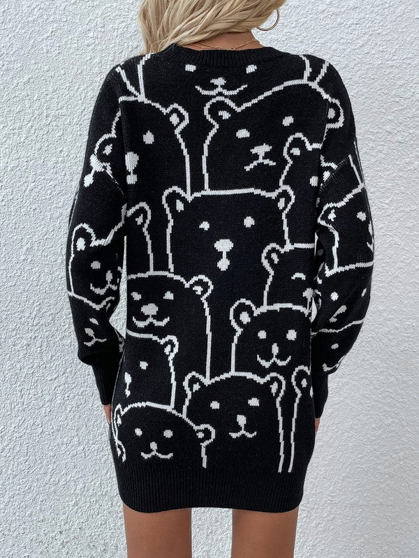A person wearing a Womens Long Sleeve Round Neck Pullover Sweater adorned with multiple bear faces stands against a white textured wall.