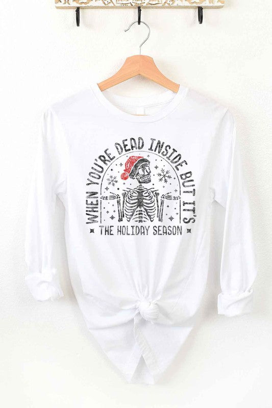 A CHRISTMAS SKELETON LONG SLEEVE TEE on a hanger, showcasing a premium cotton fabric with a Christmas skeleton in a Santa hat and the text "WHEN YOU'RE DEAD INSIDE BUT IT'S THE HOLIDAY SEASON".