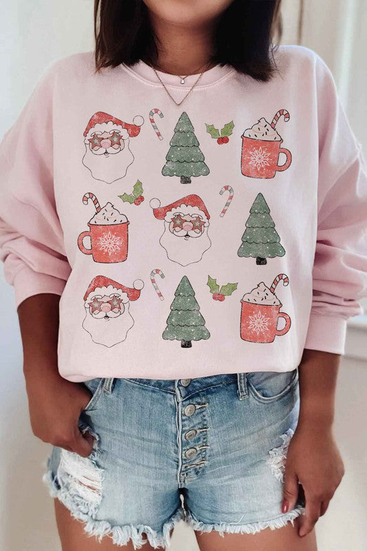 Person wearing the CHRISTMAS COLLECTION GRAPHIC SWEATSHIRT in light gray, featuring festive prints of Santa faces, hot cocoa mugs, Christmas trees, and candy canes, paired with denim shorts.