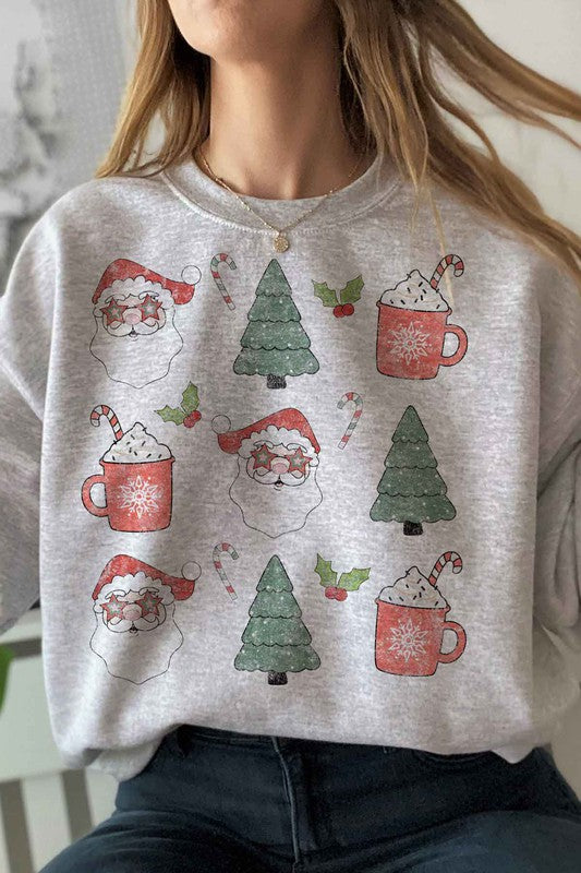 Person wearing the CHRISTMAS COLLECTION GRAPHIC SWEATSHIRT in light gray, featuring festive prints of Santa faces, hot cocoa mugs, Christmas trees, and candy canes, paired with denim shorts.