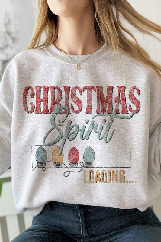 Person wearing the Loading Christmas Spirit Graphic Sweatshirt, featuring the text "Christmas Spirit Loading..." and colorful Christmas lights, perfect for your holiday wardrobe. Unisex sizing ensures a comfortable fit for everyone.