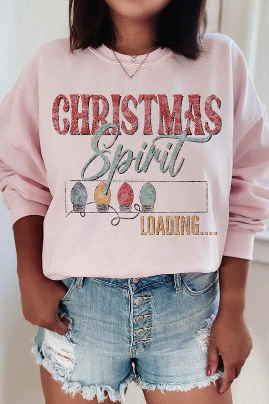 Person wearing the Loading Christmas Spirit Graphic Sweatshirt, featuring the text "Christmas Spirit Loading..." and colorful Christmas lights, perfect for your holiday wardrobe. Unisex sizing ensures a comfortable fit for everyone.