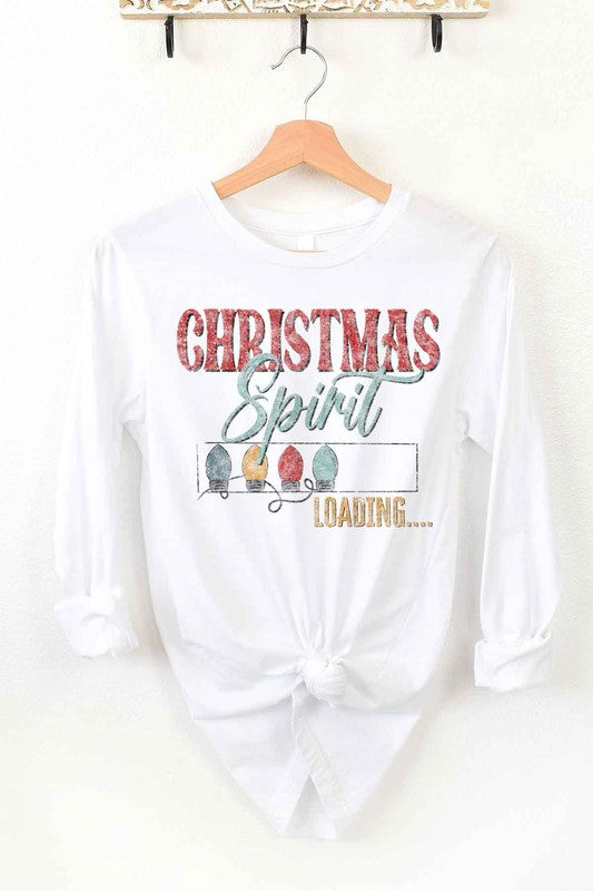 White long-sleeve CHRISTMAS TREE FARM tee on a wooden hanger with the text "Christmas Spirit Loading..." and images of Christmas lights. This premium cotton shirt features a front tie knot, perfect for adding festive flair to your holiday wardrobe.