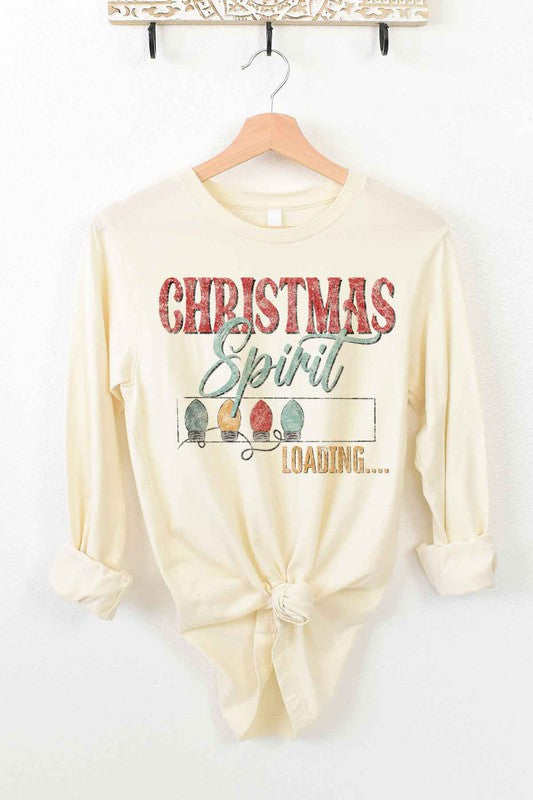 White long-sleeve CHRISTMAS TREE FARM tee on a wooden hanger with the text "Christmas Spirit Loading..." and images of Christmas lights. This premium cotton shirt features a front tie knot, perfect for adding festive flair to your holiday wardrobe.