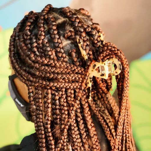 Two different colored Barely There Hair Claws placed on a light-colored surface.