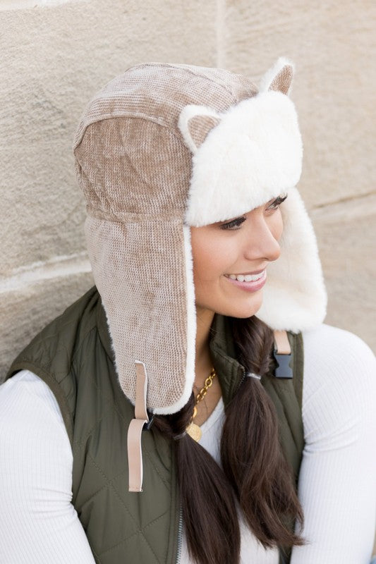 Woman smiling while wearing a Kitten Ear Trapper Hat with faux fur earflaps.
