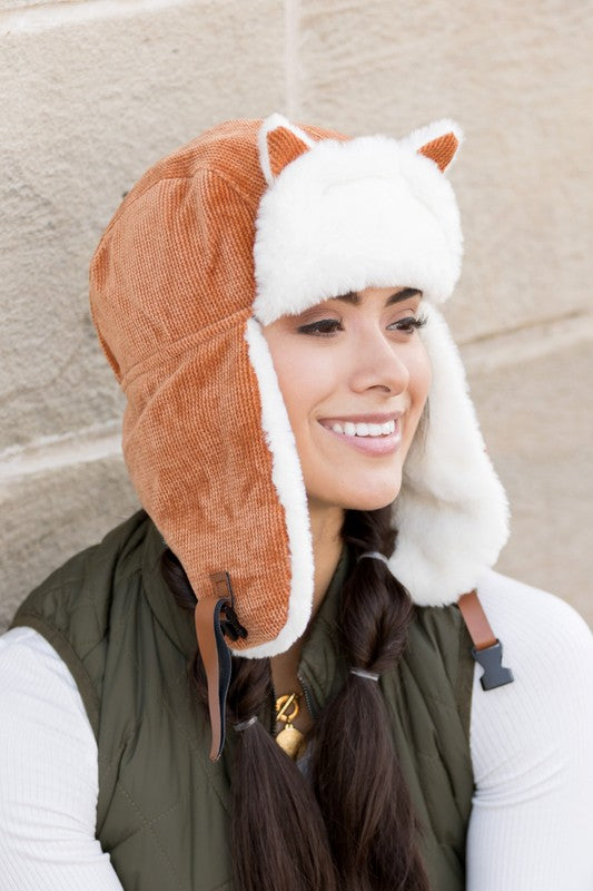 Woman smiling while wearing a Kitten Ear Trapper Hat with faux fur earflaps.