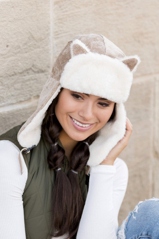 Woman smiling while wearing a Kitten Ear Trapper Hat with faux fur earflaps.