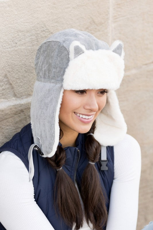Woman smiling while wearing a Kitten Ear Trapper Hat with faux fur earflaps.