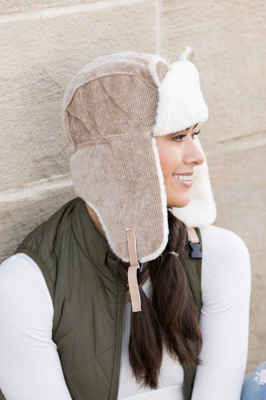 Woman smiling while wearing a Kitten Ear Trapper Hat with faux fur earflaps.