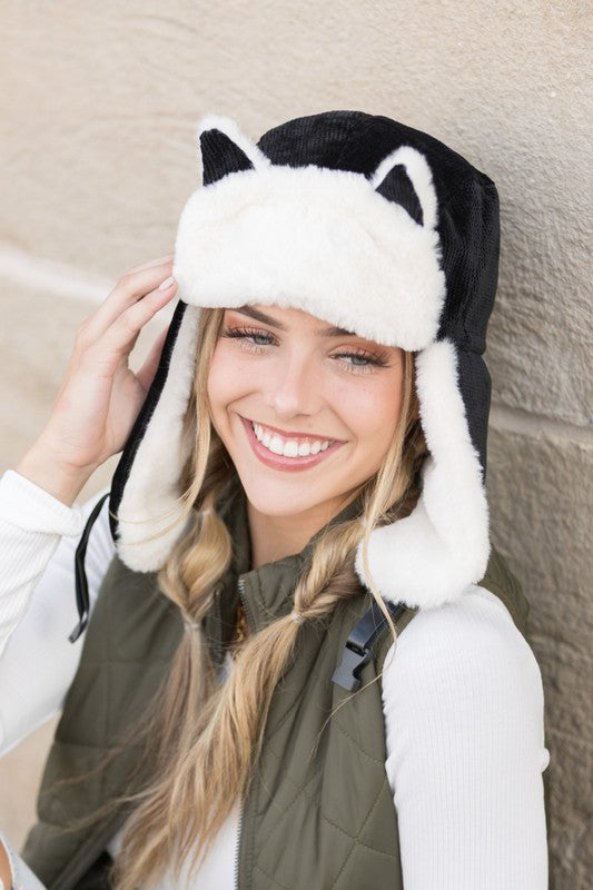 Woman smiling while wearing a Kitten Ear Trapper Hat with faux fur earflaps.