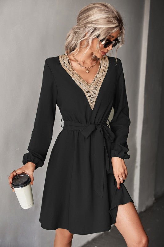 A person in sunglasses is wearing a Women's Long Sleeve V Neck Mid Dress in green, holding a coffee cup.