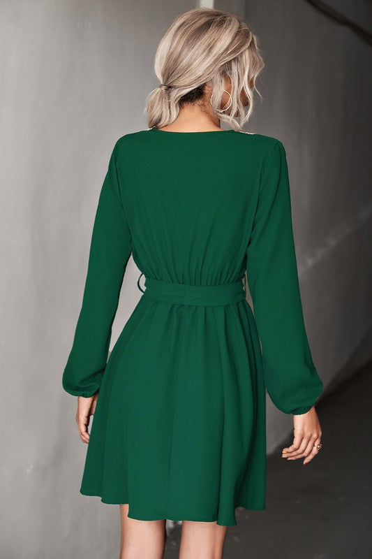 A person in sunglasses is wearing a Women's Long Sleeve V Neck Mid Dress in green, holding a coffee cup.