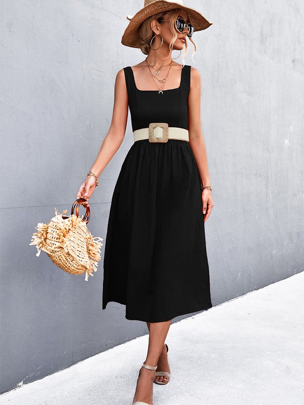 A woman in a Women's Sleeve Less Dress, featuring a vibrant red hue and crafted from 100% polyester, stands against a gray wall. She accessorizes with a wide-brimmed hat, holds a straw handbag, and complements her outfit with beige sandals.